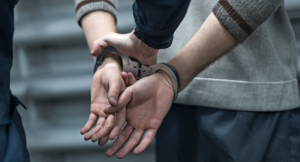 handcuffs on the prisoner. Making an arrest. Remand in custody