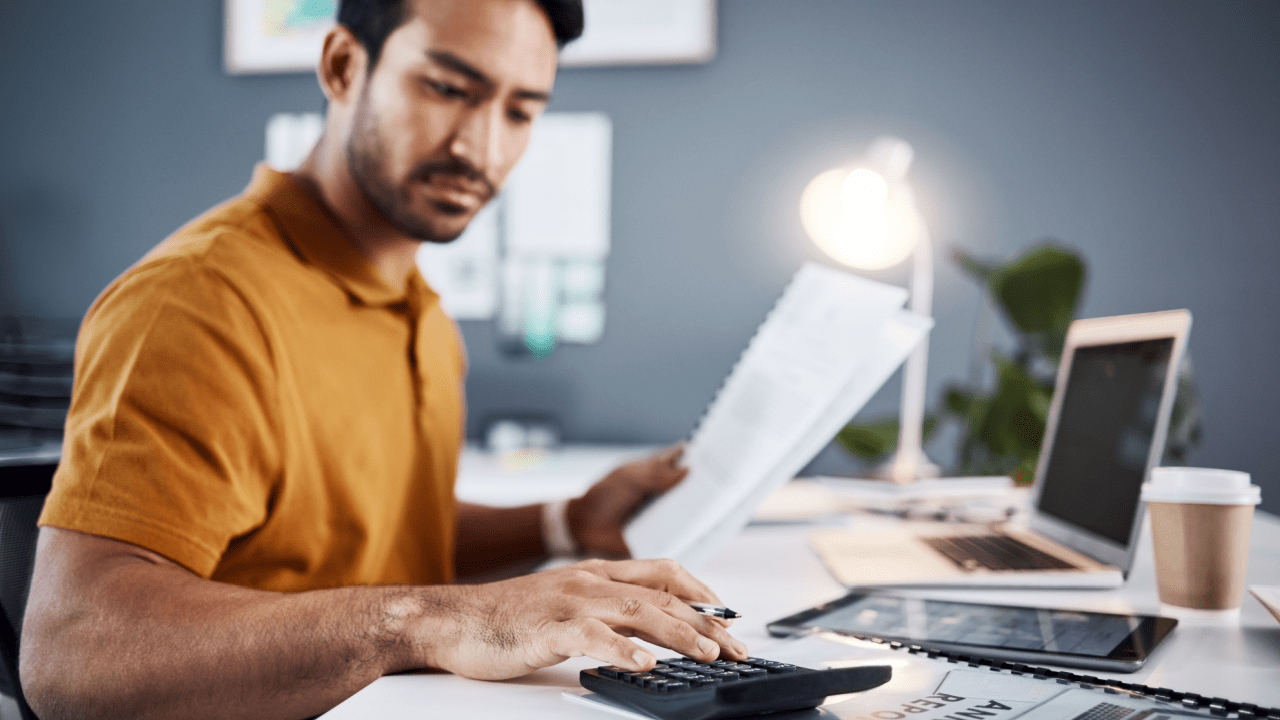 Man reviews IRS notice and credit report with a document showing credit score and debt impact.