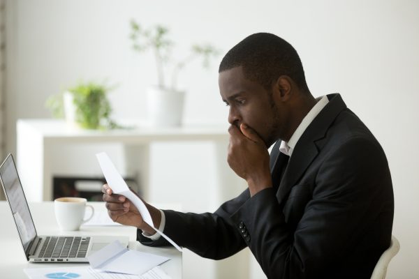 Taxpayer examining IRS CP40 notice on a desk with tax documents, symbolizing debt assignment to private collectors, not debt sales.