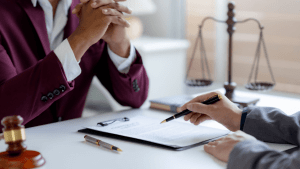 Estate attorney explains IRS debt after death to a client during a consultation.