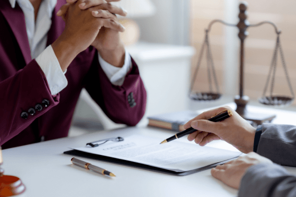 Estate attorney explains IRS debt after death to a client during a consultation.