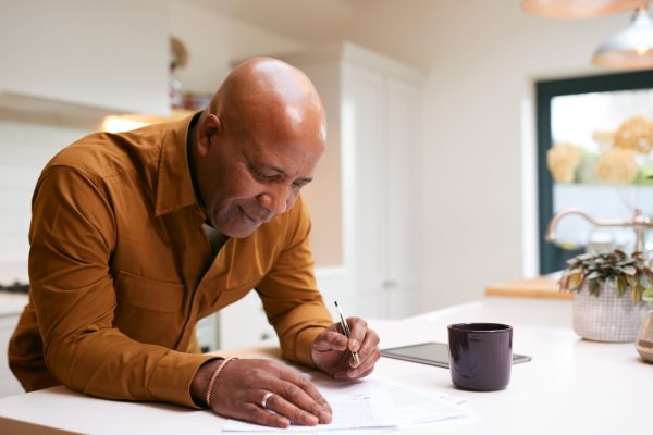 Man reviews IRS account transcript showing CSED and tax debt expiration documents.