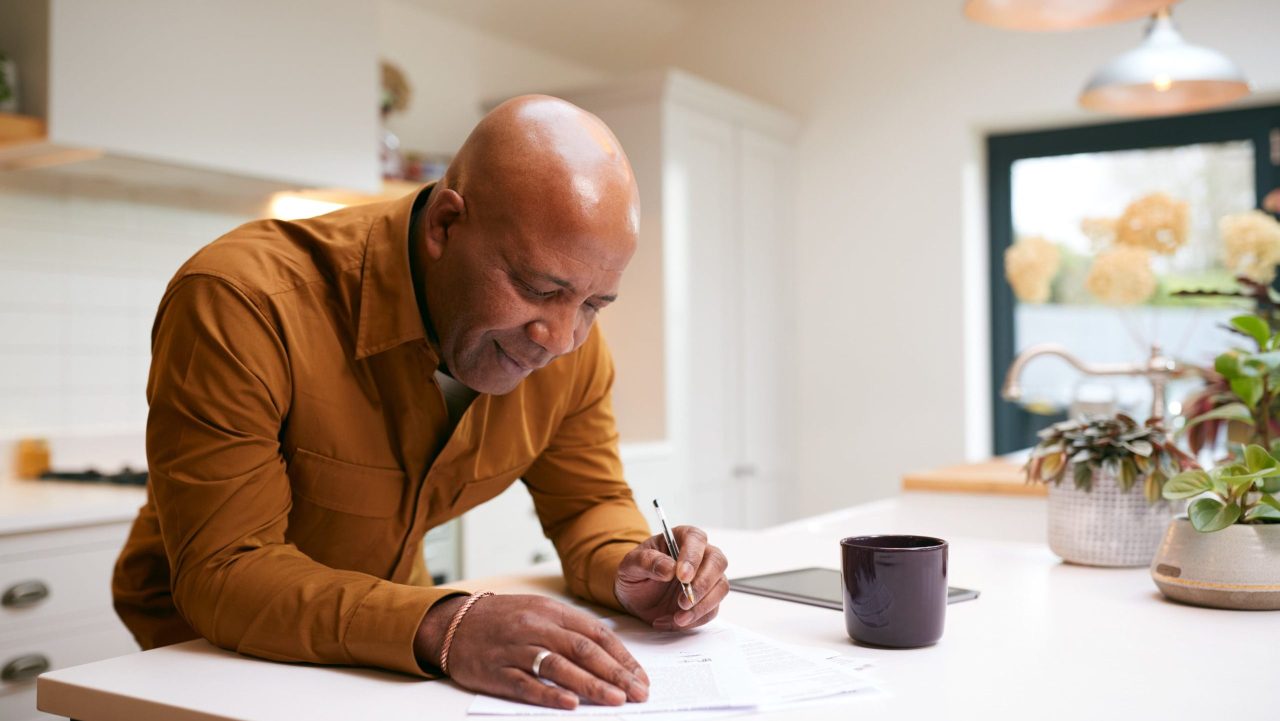 Man reviews IRS account transcript showing CSED and tax debt expiration documents.