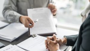 Probate attorney explains inherited tax debt to client during estate consultation.