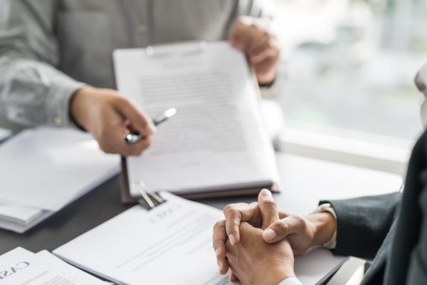 Probate attorney explains inherited tax debt to client during estate consultation.