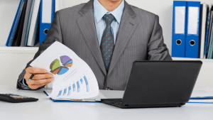 Man reviews IRS Form 1099-C and a chart comparing taxable and non-taxable canceled debt.
