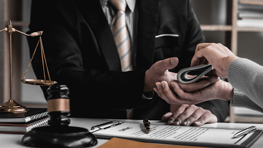 Lawyer in suit with scales of justice consulting client about IRS debt relief scams and legal protection