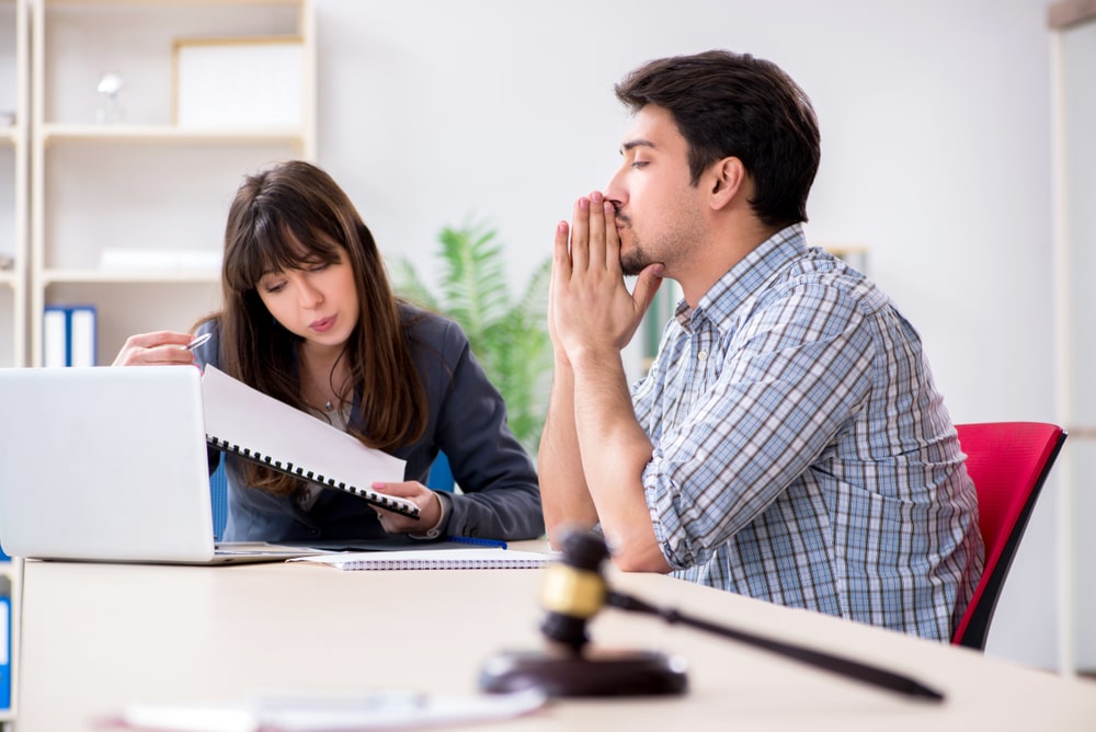 Concerned man consulting lawyer about IRS debt and estate issues