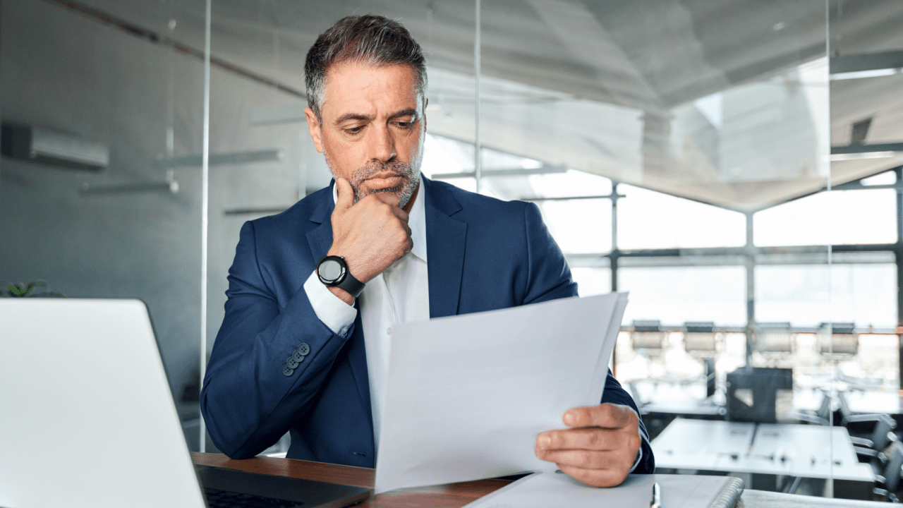 Business professional reviewing bankruptcy documents wondering can IRS debt be included in Chapter 13 filing