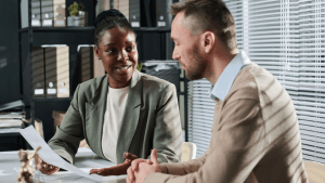 Tax professional consulting client about can you reduce IRS debt through settlement and relief programs