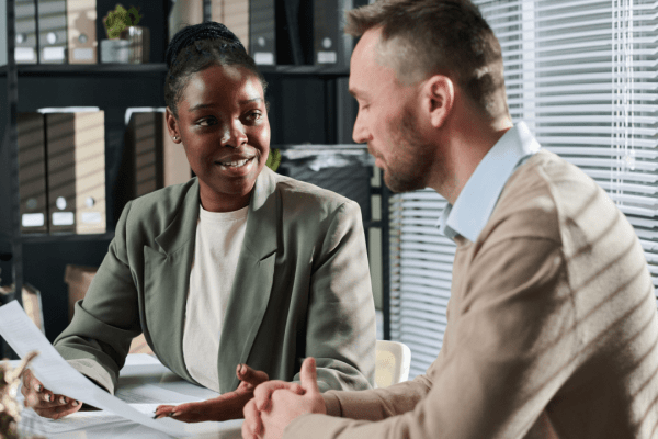 Tax professional consulting client about can you reduce IRS debt through settlement and relief programs