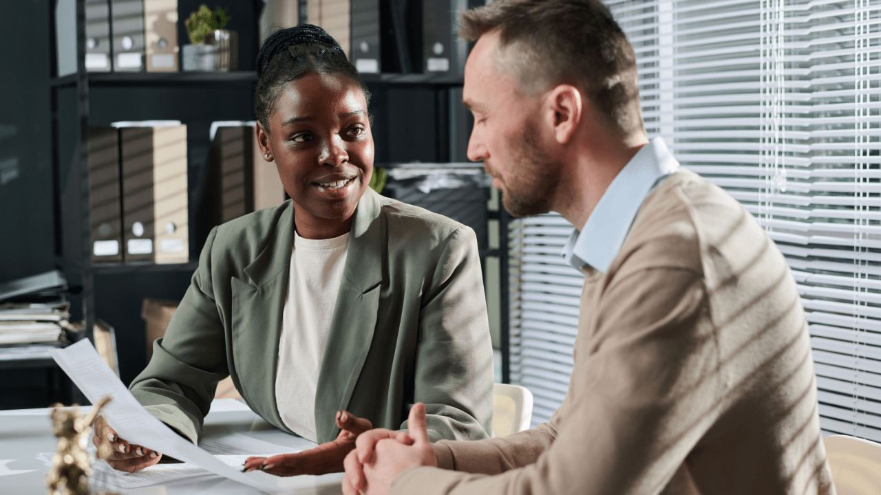 Tax professional consulting client about can you reduce IRS debt through settlement and relief programs