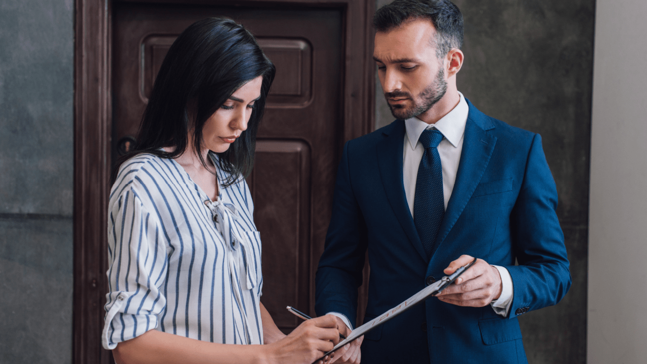Woman signing documents with professional man in suit representing does IRS use debt collectors scenario