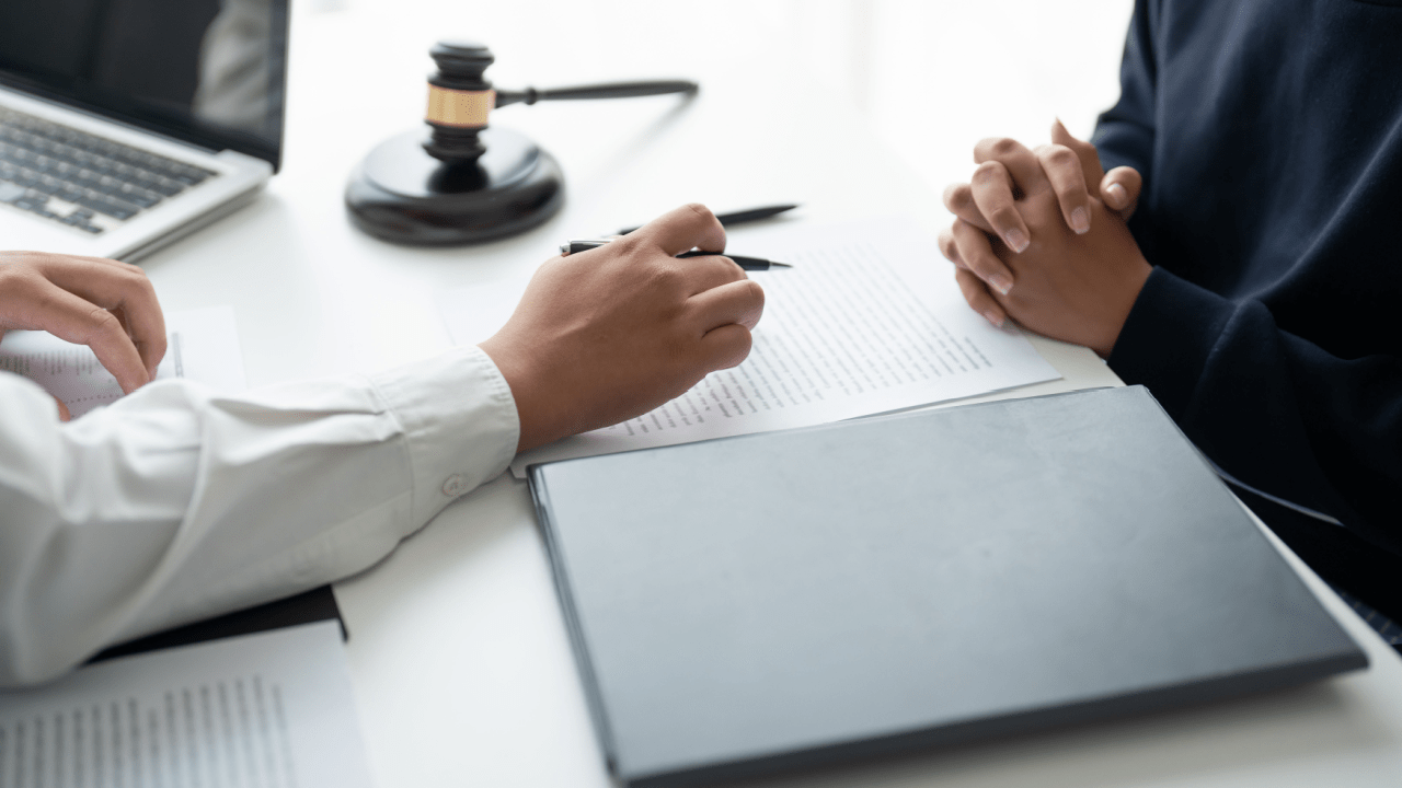Legal consultation about how to clear tax debt with an attorney reviewing documents and a gavel on the desk