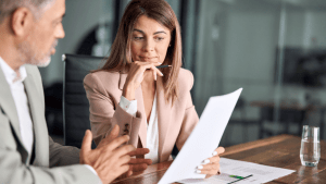 Woman reviewing bankruptcy documents with an attorney discussing IRS debt and Chapter 7 filing options