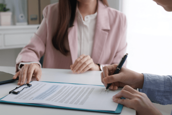 Professional consultation where client reviews tax debt services reviews and signs agreement for tax resolution help