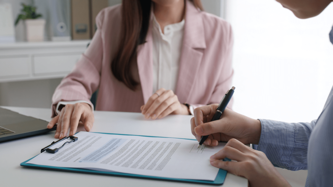 Professional consultation where client reviews tax debt services reviews and signs agreement for tax resolution help