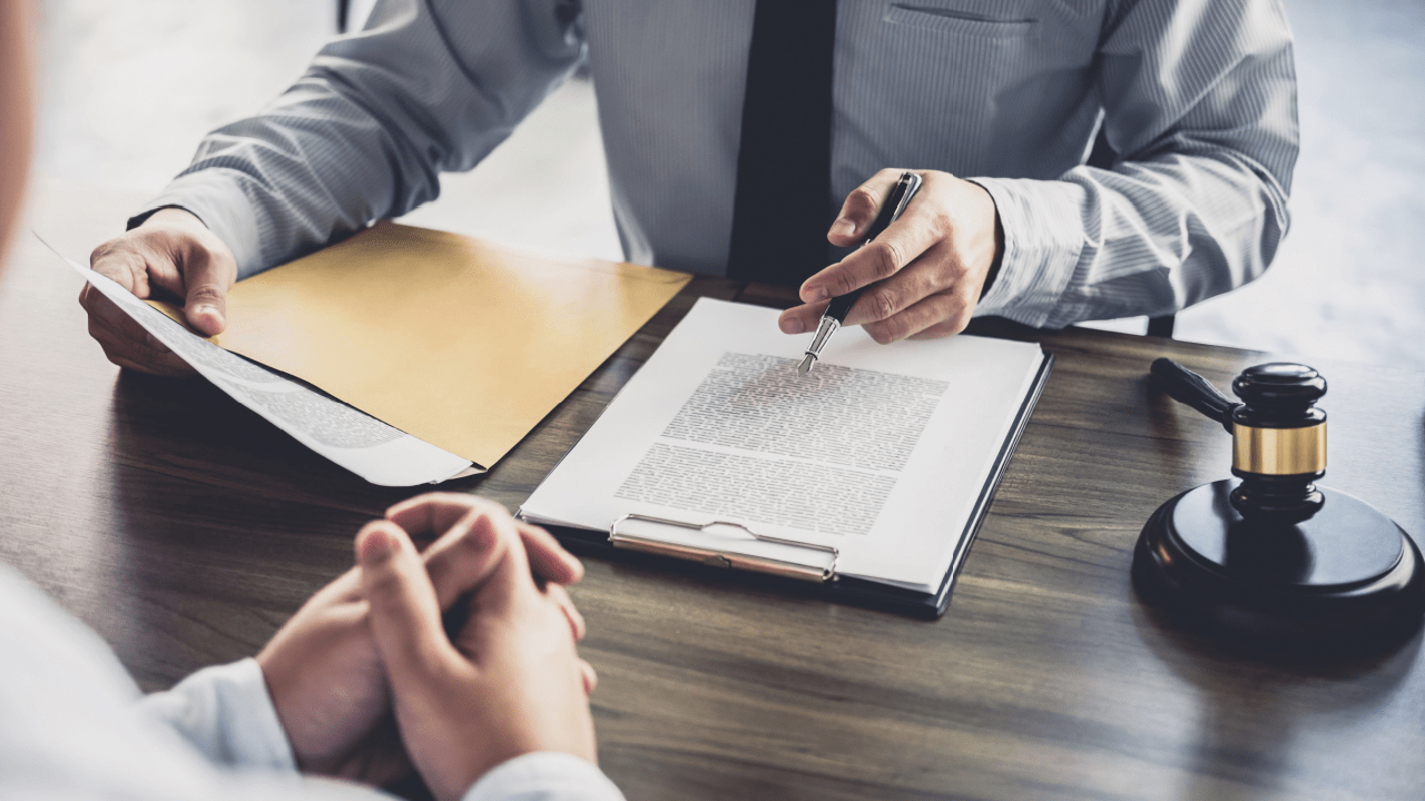 Attorney reviewing legal documents about tax deduction for bad debt with client consultation and gavel