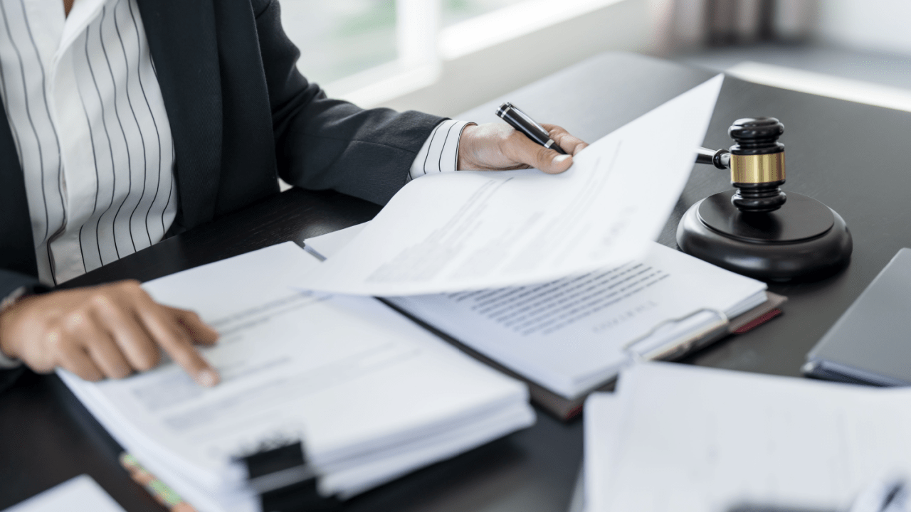 Legal professional reviewing documents about US tax debt resolution with a gavel and official paperwork