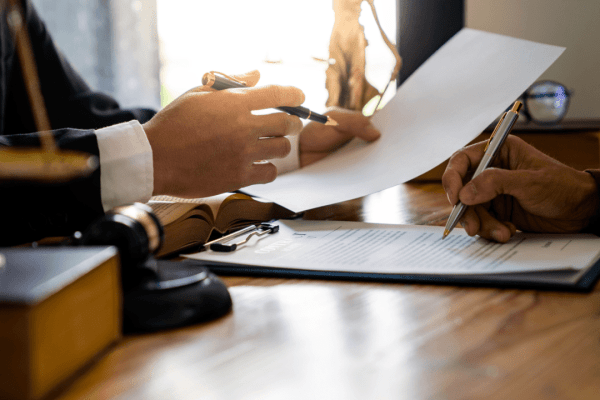 Legal professional reviewing documents about what is tax debt forgiveness with a gavel and official papers