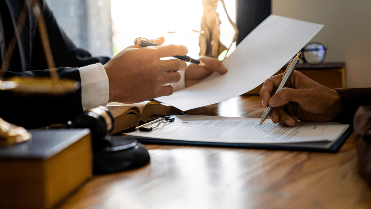 Legal professional reviewing documents about what is tax debt forgiveness with a gavel and official papers