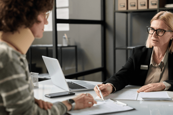 Tax professional consulting a client about who qualifies for tax debt relief programs and eligibility requirements