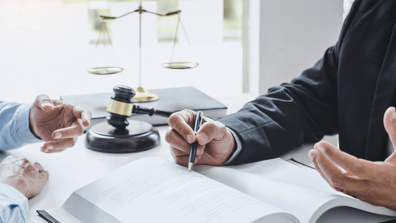 Attorney consulting with client about does tax debt go on your credit report during legal meeting with scales of justice and gavel