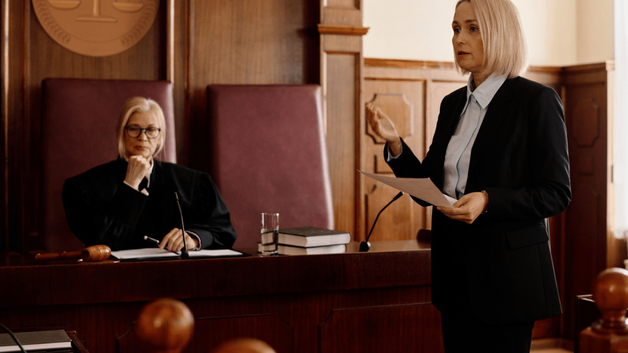 Attorney presenting case about IRS banned debt collectors in formal courtroom before judge during legal proceedings