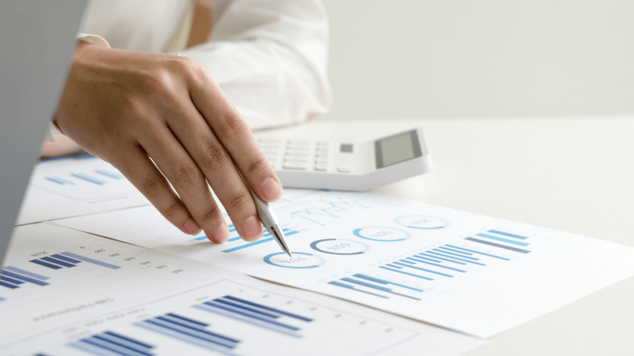 Person analyzing financial charts and using calculator while researching can I negotiate with the IRS myself for tax debt resolution