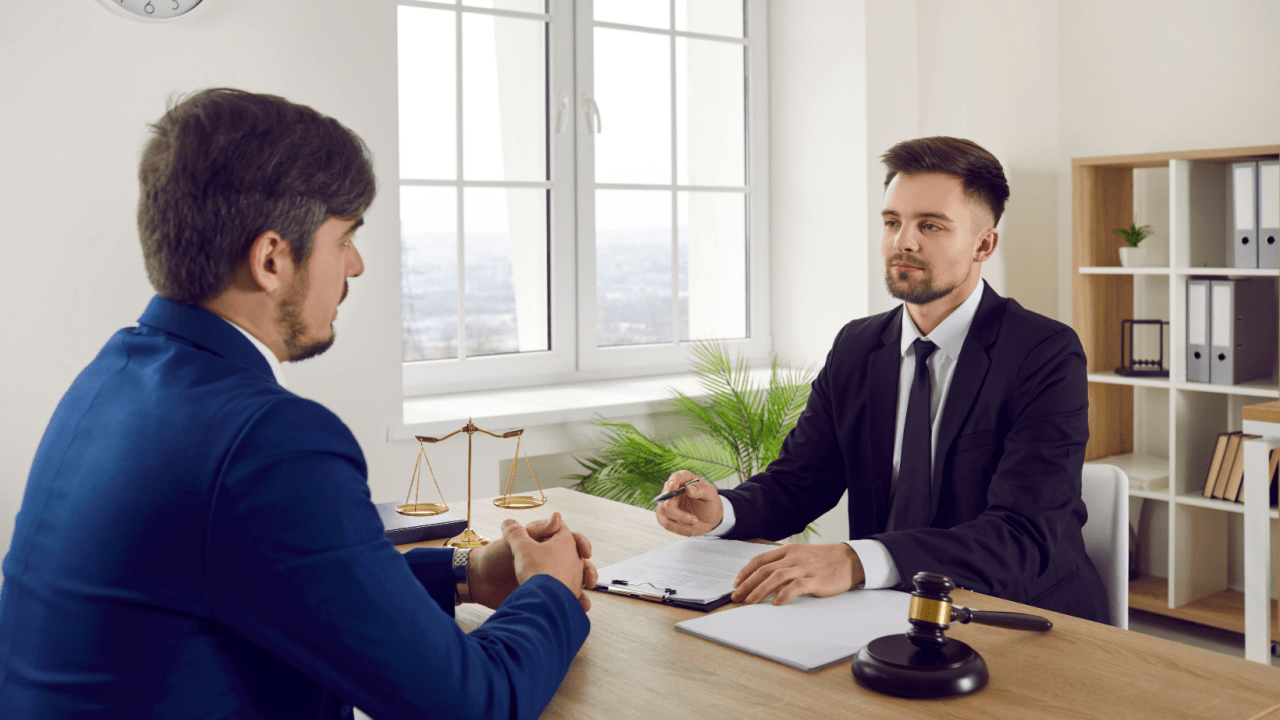 Bankruptcy attorney consulting with client about can IRS debt be included in Chapter 7 bankruptcy proceedings in professional law office