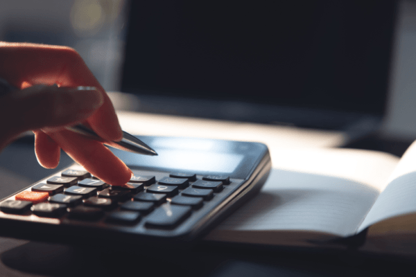 Calculator and tax documents representing IRS tax debt forgiveness after 10 years collection period