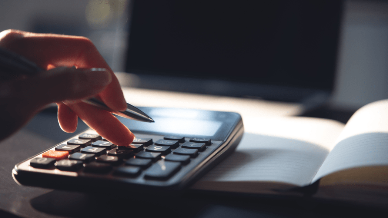 Calculator and tax documents representing IRS tax debt forgiveness after 10 years collection period