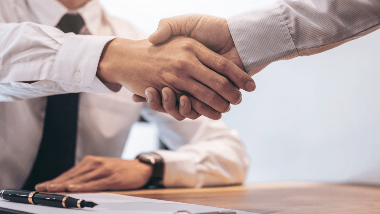 Professional handshake between tax attorney and client discussing how to get help with tax debt relief options
