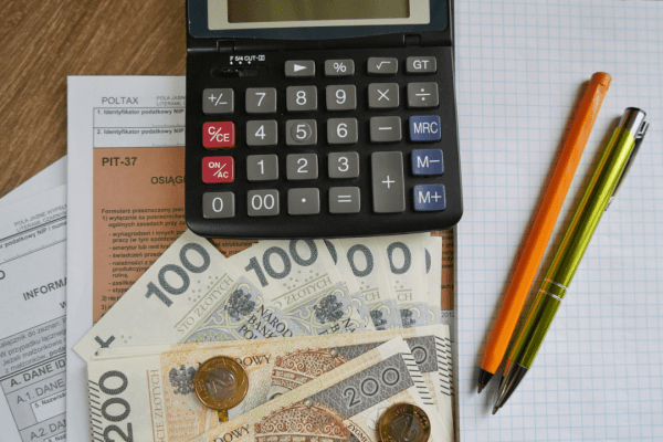 Calculator and Polish currency on tax documents showing how to settle with the IRS by yourself using financial planning tools