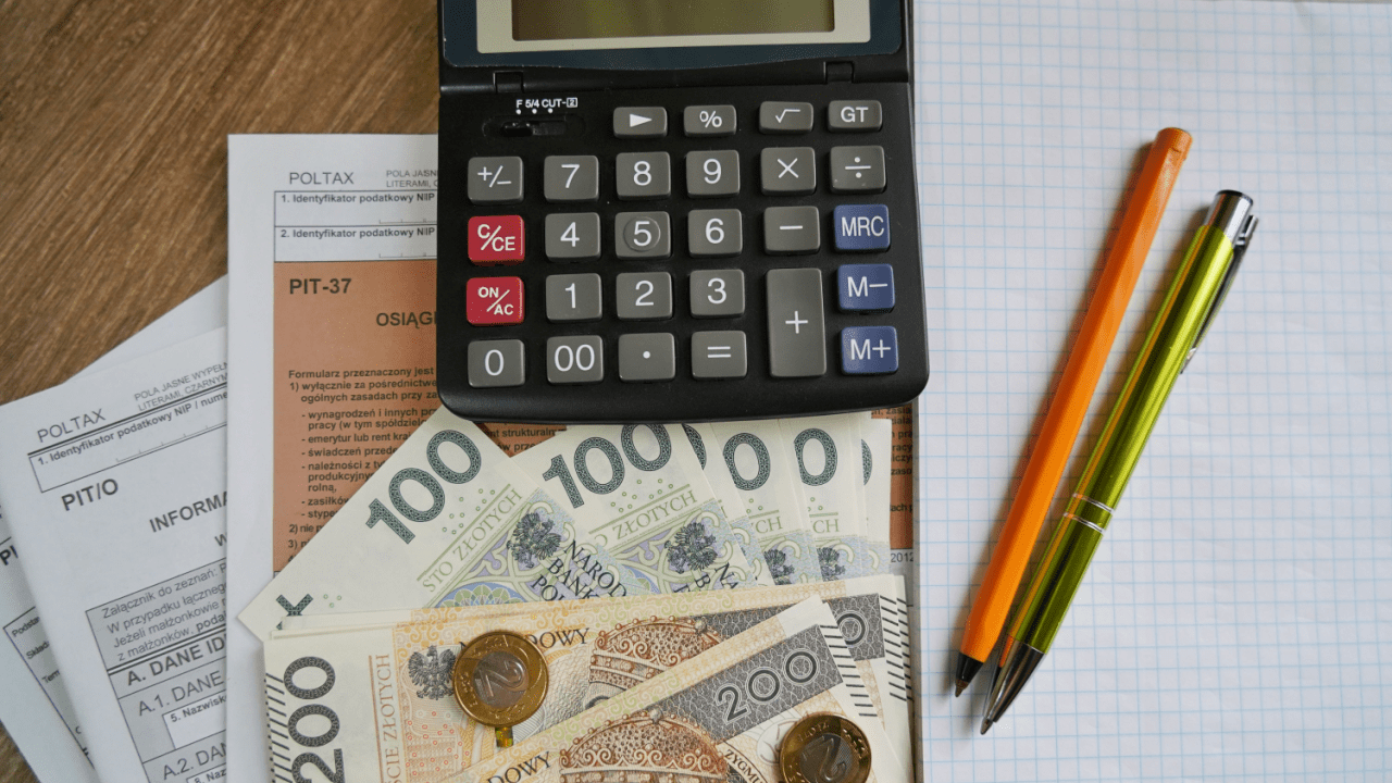 Calculator and Polish currency on tax documents showing how to settle with the IRS by yourself using financial planning tools