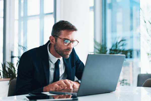 Professional tax attorney working on laptop helping clients understand what happens if you can't afford your tax debt