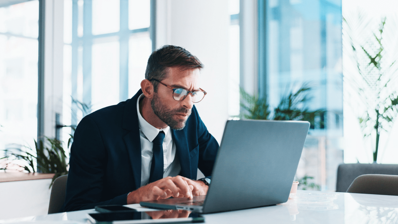 Professional tax attorney working on laptop helping clients understand what happens if you can't afford your tax debt