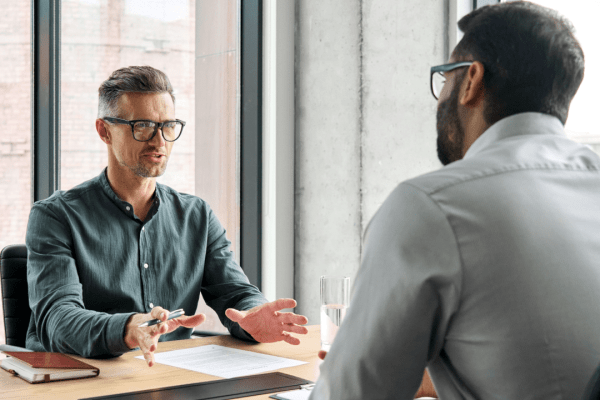 Professional tax advisor helping client with IRS debt near me during consultation meeting