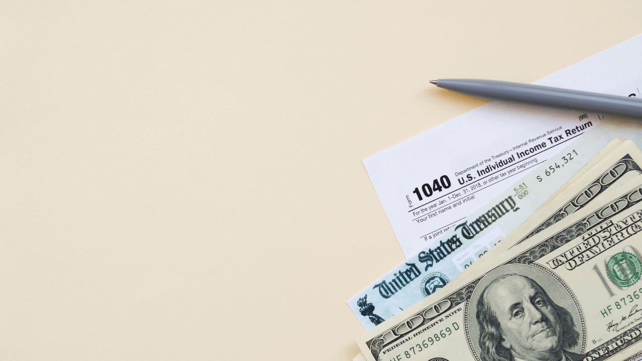 What happens if you owe the IRS more than $25,000 - tax forms, stimulus check, and cash on desk