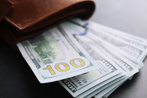 Cash and wallet representing what is the minimum payment the IRS will accept for tax debt