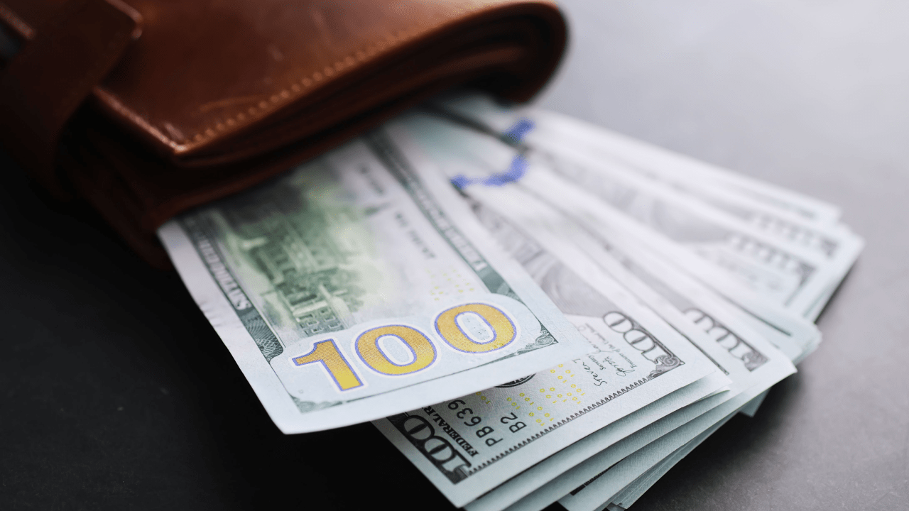 Cash and wallet representing what is the minimum payment the IRS will accept for tax debt