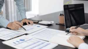Tax advisor and client reviewing financial documents to determine who is eligible for the IRS hardship program