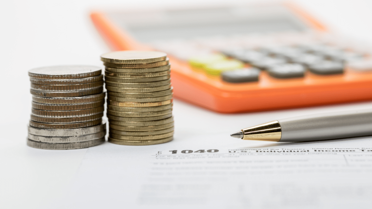 Financial alternatives and comparisons planning with coins, calculator, and tax documents on desk