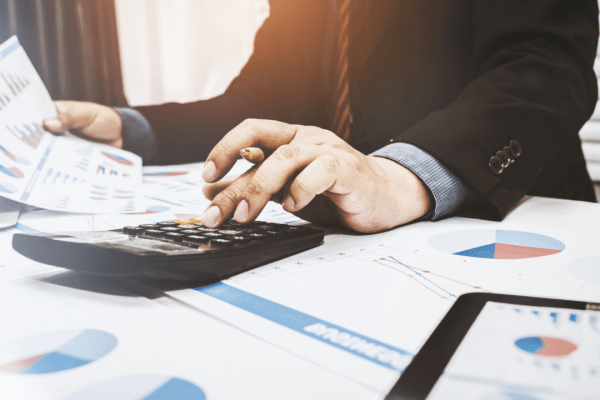 Professional calculating average cost of tax attorney services with financial documents and calculator