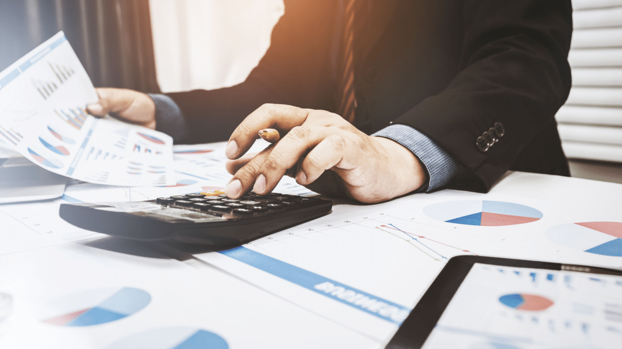 Professional calculating average cost of tax attorney services with financial documents and calculator