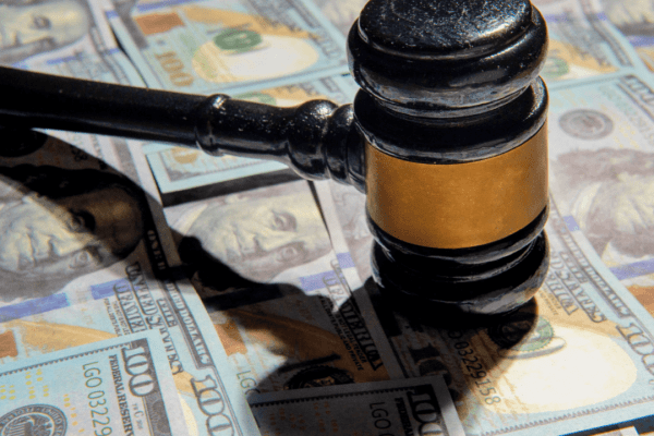 Judge gavel on money bills showing can you dispute a debt if it was sold to a collection agency legal rights