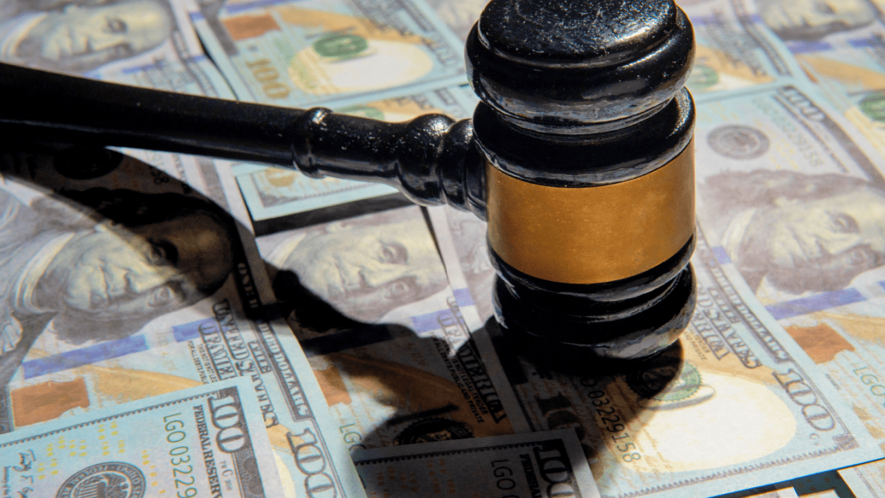 Judge gavel on money bills showing can you dispute a debt if it was sold to a collection agency legal rights