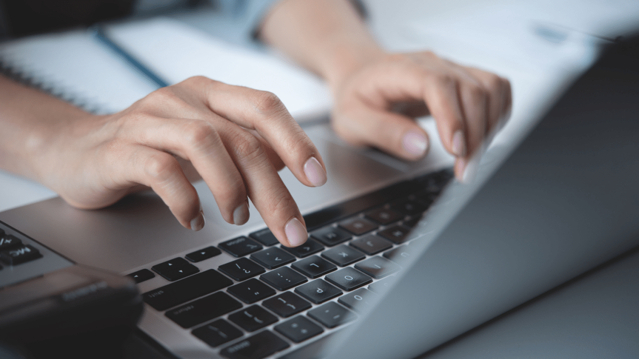 Person typing on laptop researching do I need a lawyer for back taxes online