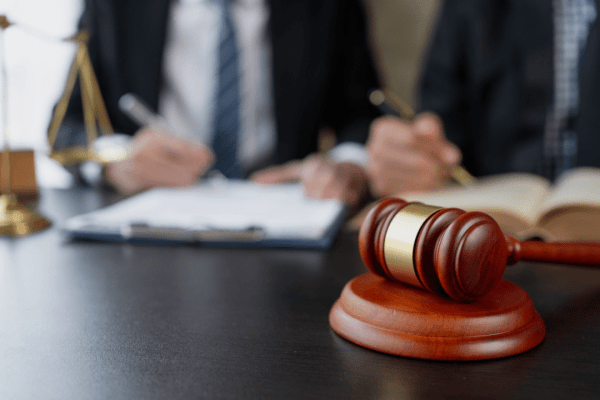 Lawyer reviewing how do I settle a debt lawsuit documents with gavel and legal scales on desk