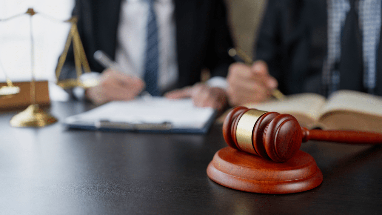 Lawyer reviewing how do I settle a debt lawsuit documents with gavel and legal scales on desk